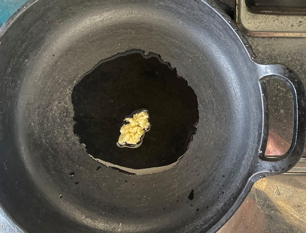 フライパンにオイルとニンニク